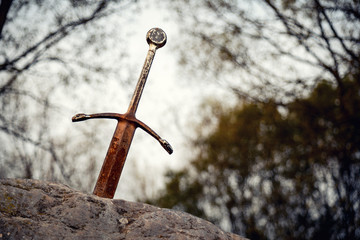 Obraz premium Excalibur the famous sword in the stone of king Arthur in the forest, Llangorse Lake, Brecon Beacons
