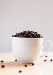 Coffee beans placed in a white cup