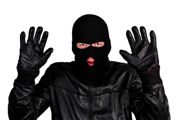 Arrested masked thief with raised arms isolated on white background