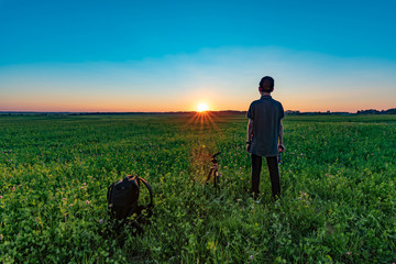 Boy looks at the sunset