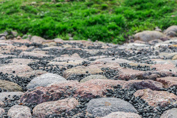 Stones against green grass background