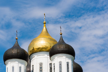 Domes of a temple on the background of a blue sky