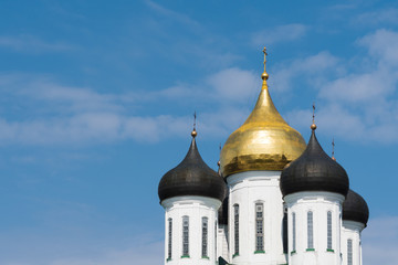 Domes of a temple on the background of a blue sky