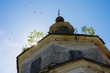 The sun behind the old church