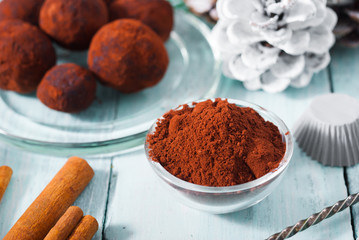 Christmas dessert chocolate truffles and spices on white wood