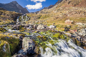 Waterfall near alpine lake, Lac long, Valpelline, Aosta Valley, Bionaz, Italy