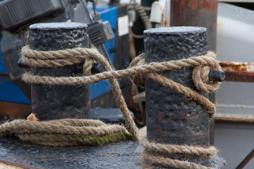 Fototapeta na wymiar rope tied around boat mooring cleats