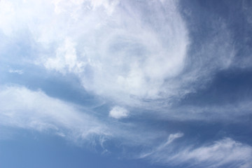 White clouds circular formation over deep blue sky horizontal