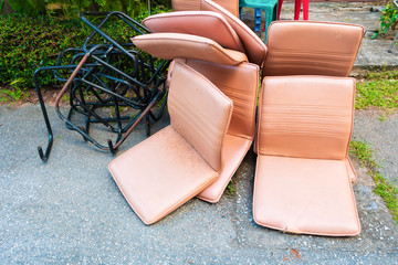 office chair leather brown old damage dirty heap on the floor road