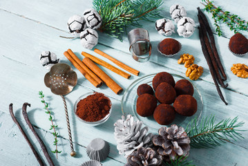 Christmas dessert chocolate truffles and spices on white wood