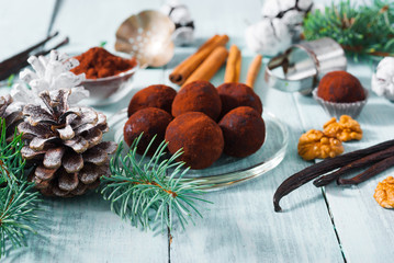 Christmas dessert chocolate truffles and spices on white wood