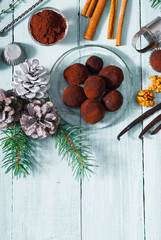 Christmas dessert chocolate truffles and spices on white wood