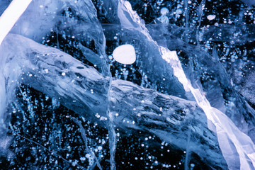 Obraz na płótnie Canvas Blue cracked surface of the ice surface