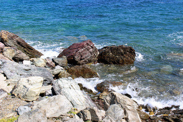 Sea water coastline with dark and light rocks