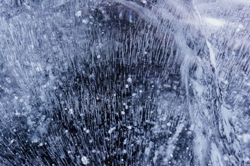 Fototapeta na wymiar Blue cracked surface of the ice surface