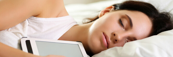 Young beautiful brunette woman portrait lying in bed sleeping