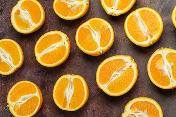 Halves of oranges on a dark.