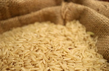 Closed Up Heap of Raw Thai Brown Jasmine Rice in a Natural Hemp Sack