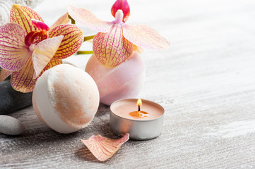 Spa still life with bath bombs and red orange orchid