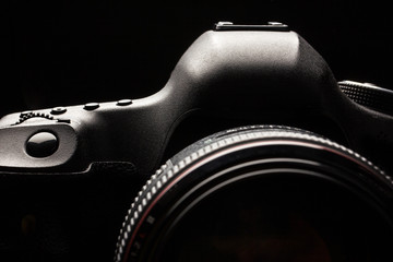 Professional modern DSLR camera low key image - Modern DSLR camera with a very wide aperture lens on - obrazy, fototapety, plakaty