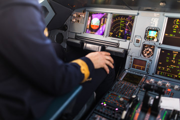 Pilot's hand accelerating on the throttle in  a commercial airliner airplane flight cockpit during...
