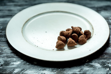 sweet, chocolate truffles and bitter cocoa on a romantic, dark background