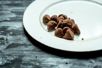 sweet, chocolate truffles and bitter cocoa on a romantic, dark background