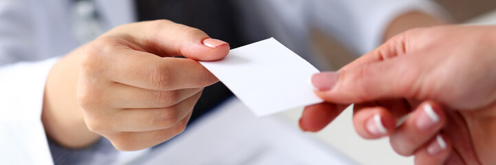Female physician hand give white blank calling card