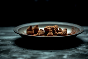 sweet, chocolate truffles and bitter cocoa on a romantic, dark background