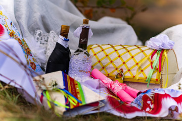 Naklejka na ściany i meble Wedding items, composition of festive paraphernalia for the wedding. Colorful scenery in nature, photo for memory. Represents tenderness and romance of the celebration.