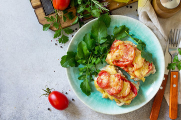 Meat chops with tomato on stone table. Festive dinner or lunch. Top view flat lay background. Copy space.