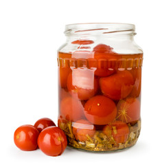 Open jar of pickled tomatoes close up on a white. Isolated.
