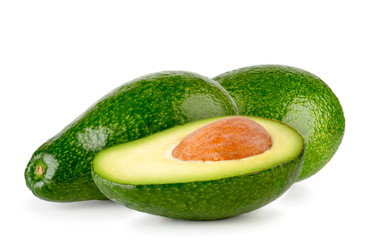 Two avocados and a half with a seed on a white background,