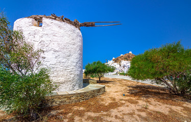 Fototapeta na wymiar Traditional houses, wind mills and churches in Ios island, Cyclades, Greece.