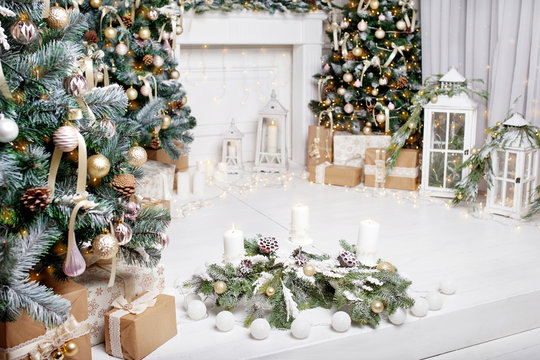Christmas decor. Christmas tree decorations and holiday homes. New Year's interior with a fir tree in white tones