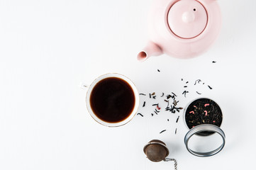 top down view of tea pot, tea leaves and tea cup