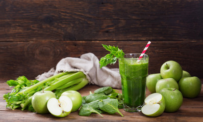 glass of green juice smoothie with spinach, apple and celery