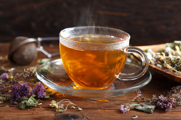 Cup of herbal tea with various herbs