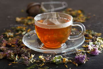 Cup of herbal tea with various herbs