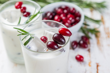 White christmas margarita punch with rosemary on wood background
