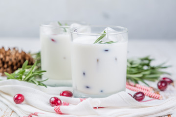 White christmas margarita punch with rosemary on wood background