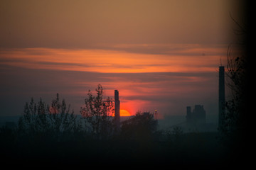Fiery crimson sunset on the background of the city