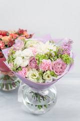European floral shop. Two Bouquet Mixed beautiful flowers on wooden gray table. Nice garden flowers in the arrangement , the work of a professional florist.