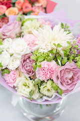European floral shop. Bouquet Mixed beautiful flowers on wooden gray table. Nice garden flowers in the arrangement , the work of a professional florist.