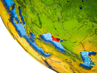 Crimea on model of Earth with country borders and blue oceans with waves.