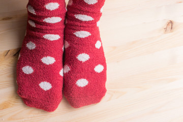 Feet in socks on wooden floor