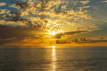 Beautiful sunset over endless sea with reflection in the water
