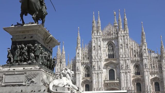 The Milan Cathedral (Duomo di Milano) and monument to Victor Emanuel II in the Piazza del Duomo in Milan, Italy, slider dolly shot 4k