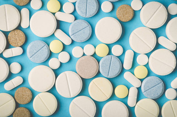 tablets of different shapes on a blue background close-up, top view