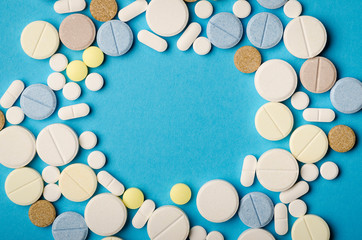tablets of different shapes on a blue background close-up, empty space in the center